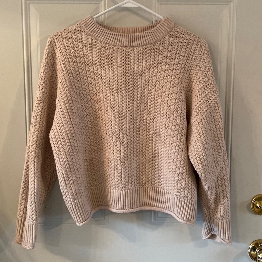 Cream colored knit sweater.